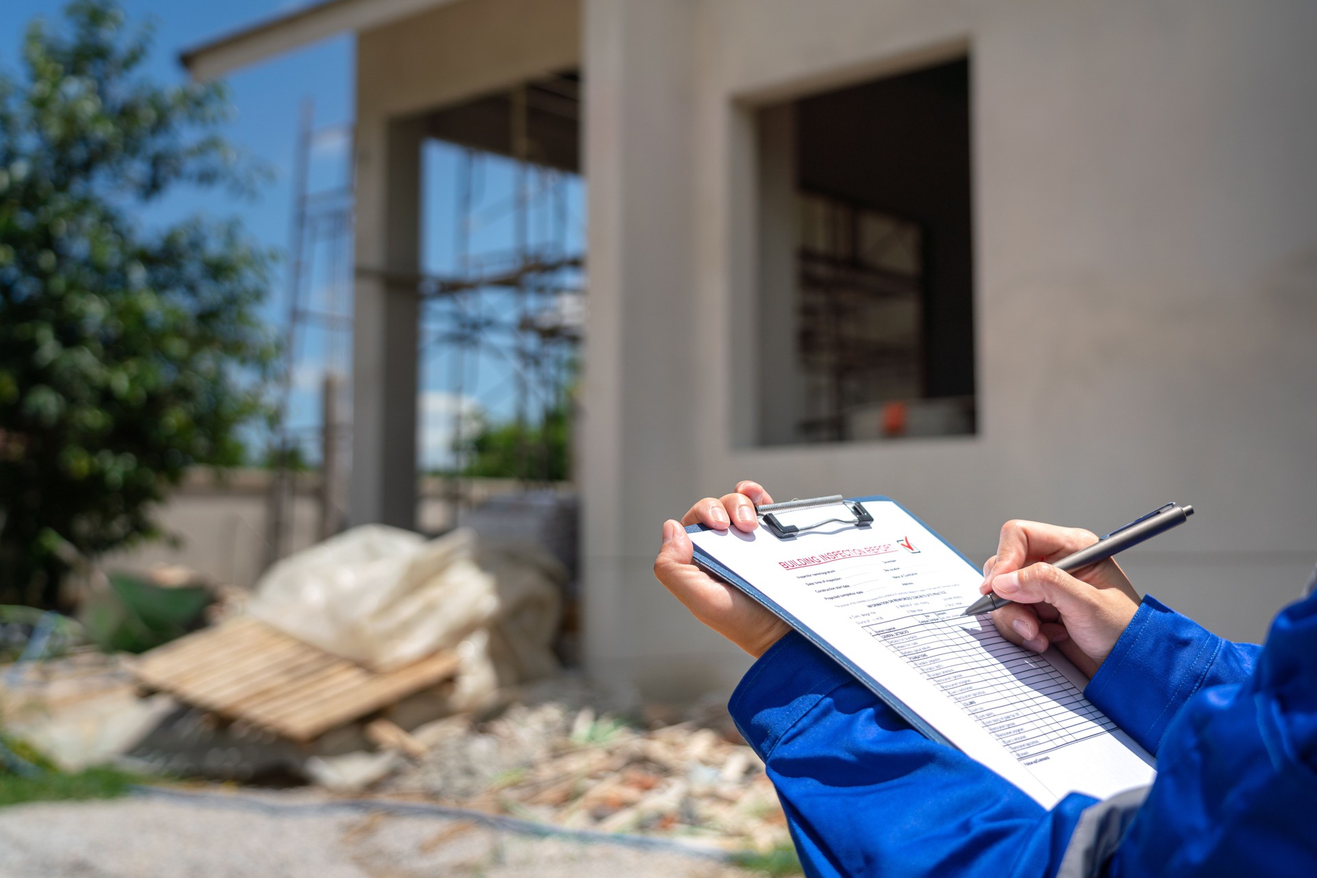 An architect is checking on house building quality checklist.